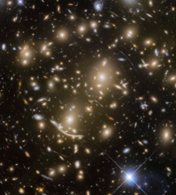 Galaxy cluster Abell 370 is shown in its entirety in this image taken with NASA's Hubble Space Telescope. The lensed galaxy known as "Dragon Arc," far beyond Abell 370, is visible to the lower left of center.