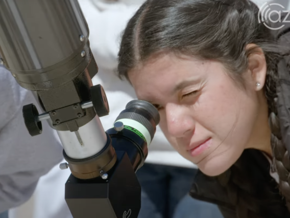 Student peers through telescope on Mt. Lemmon