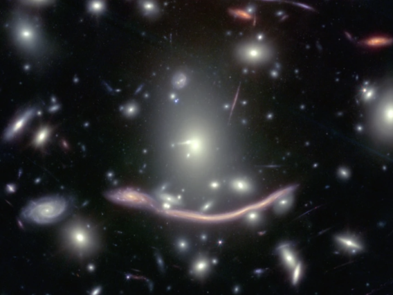 Abell 370, a galaxy cluster located nearly 4 billion light-years away from Earth features several arcs of light, including the "Dragon Arc" (below center). Such arcs are caused by gravitational lensing: Light from distant galaxies far behind the massive galaxy cluster coming toward Earth is bent around Abell 370 by its massive gravity, resulting in contorted images.