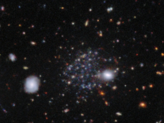 Sculptor A, one of three newly discovered dwarf galaxies - and unrelated to the well-known Sculptor spiral galaxy - is visible here as a faint accumulation of stars beyond several bright stars in the foreground.