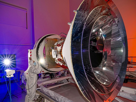 NASA’s SPHEREx observatory is oriented in a horizontal position, revealing all three layers of photon shields as well as the telescope. This photo was taken at BAE Systems in Boulder, Colorado, in April 2024. NASA/JPL-Caltech/BAE Systems