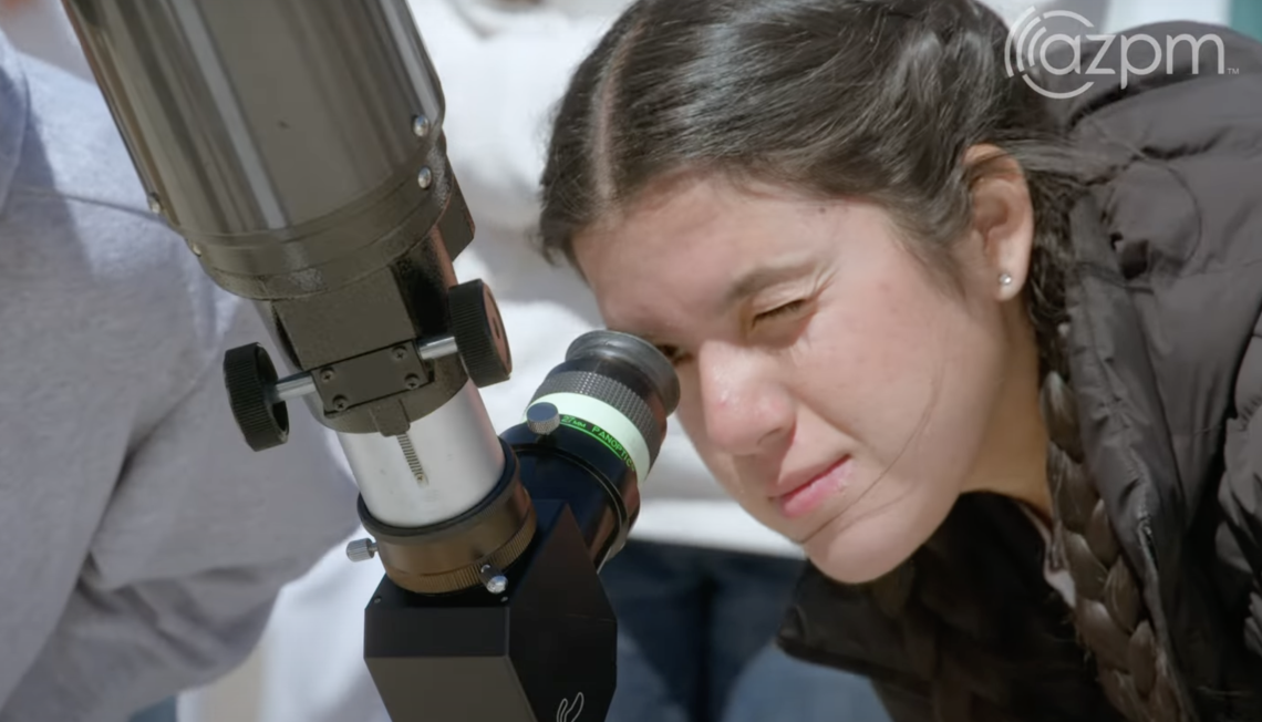 Student peers through telescope on Mt. Lemmon