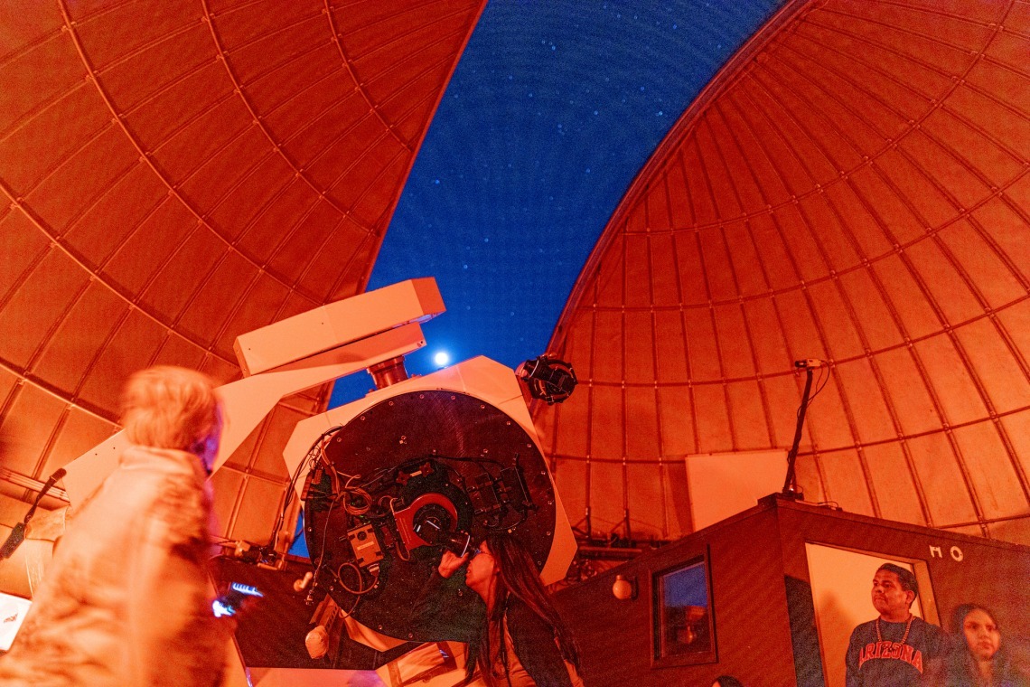 Lisa Garcia peers through a Mt. Lemmon SkyCenter telescope