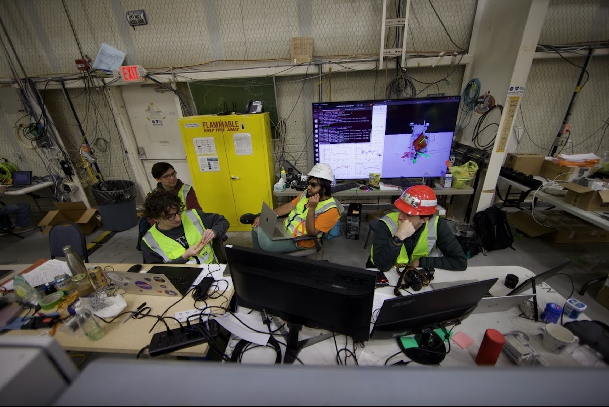 TIM flight operations crew in the command center installed in the Fort Sumner high bay. Live telemetry from the balloon is displayed on monitors around the room. Left to right: Dr. Ian Lowe (UArizona), Alexander Manduco (UPenn), Shubh Agrawal (UPenn), Evan Mayer (UArizona)