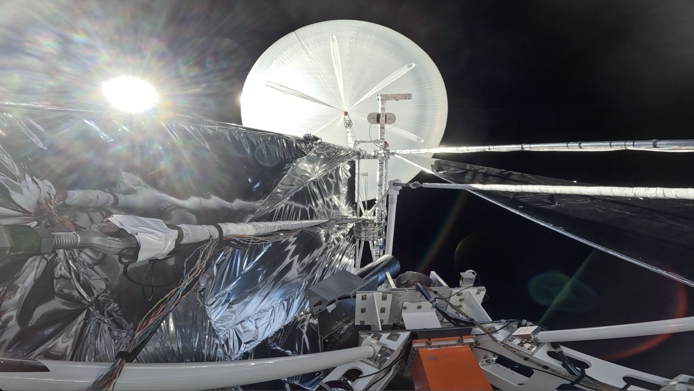 Action camera footage looking up at the suspension cables and helium balloon. TIM is at float above >99% of the atmosphere, so while the sun is out, the sky is black. PC: TIM Collaboration