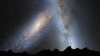 This artist's illustration shows a stage in the predicted merger between our Milky Way galaxy and the neighboring Andromeda galaxy, as it will unfold over the next several billion years. In this image, representing Earth's night sky in 3.75 billion years, Andromeda (left) fills the field of view and begins to distort the Milky Way with tidal pull.